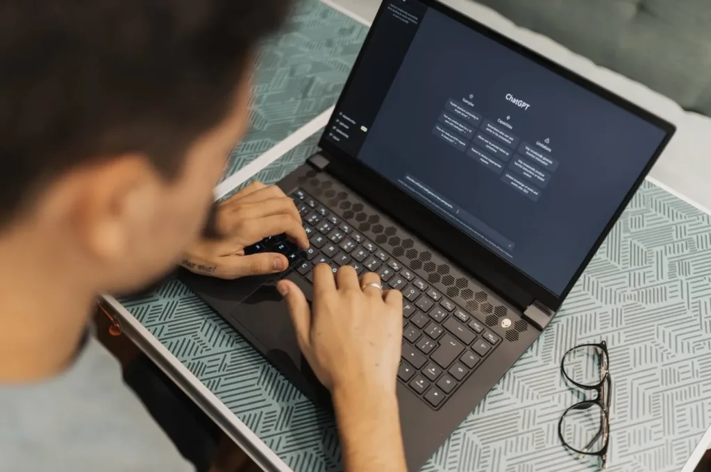 Person using ChatGPT on laptop for AI assistance